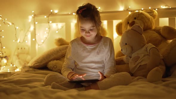 Girl Using Tablet on Bed