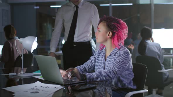 Office Manager Talk to Creative Female Employee Working on Laptop Late in Evening