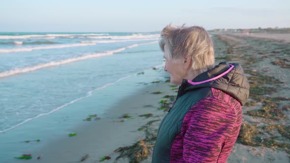 Grey Haired Woman Enjoys Picturesque Sea View From Coast