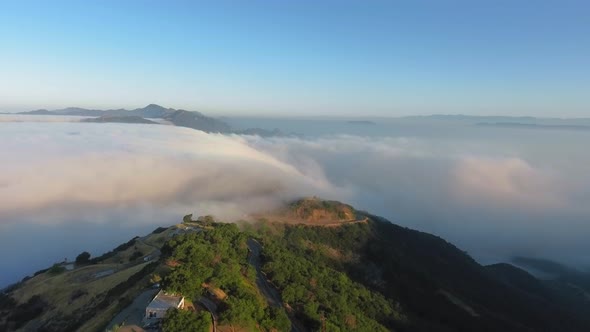 Canyon with a house by the road above the clouds in Malibu Canyon, Monte Nido, California, USA