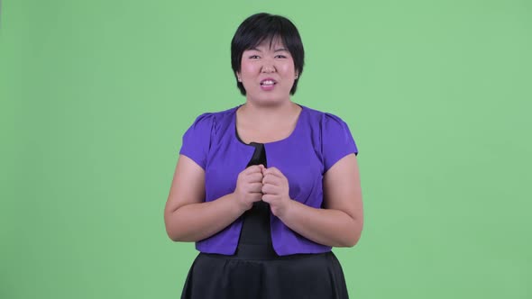 Happy Young Overweight Asian Woman Talking and Looking Excited