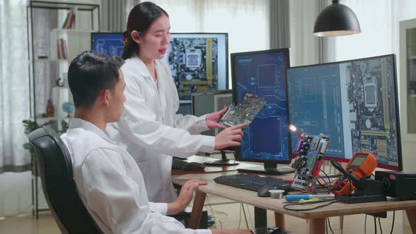 Asian Team Of Multi Engineers, Scientists Work On Computer And Motherboard, Talk, Design Pcb