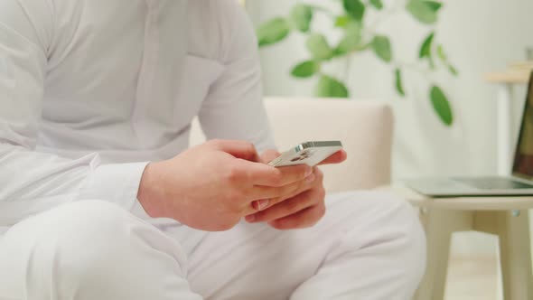 Middle Eastern Man Using Smartphone