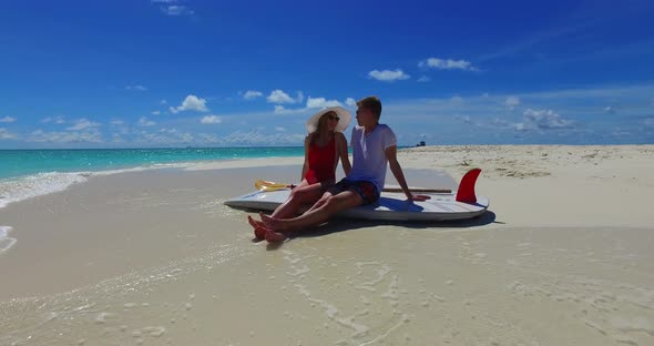 Happy boy and girl on romantic honeymoon spend quality time on beach on clean white sand background 