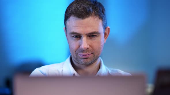 Closeup Portrait of Handsome Confident Caucasian Man with Laptop Looking at Camera