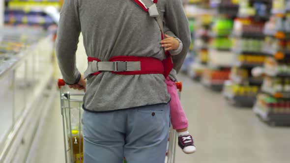 Man Carrying Baby and Buying Food