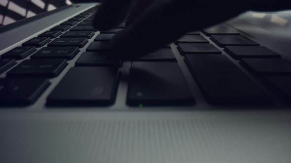 Man Hand Working on Laptop Computer. Male Fingers Typing Buttons on Laptop