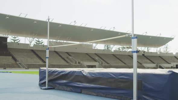 Mixed race athlete doing high jump