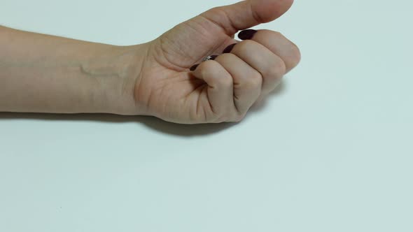 Close-up of a female hand holding pills. Headache and migraine in women treatment.