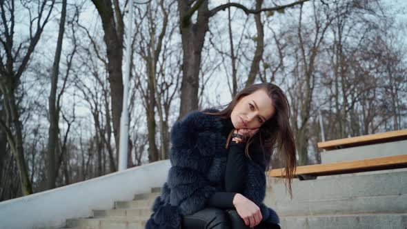 Portrait of attractive model sitting in the park. 