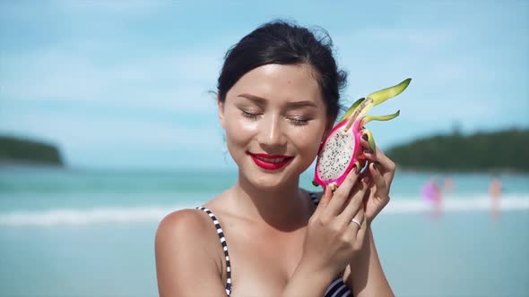 Woman Holding Dragon Fruit Beauty Concept