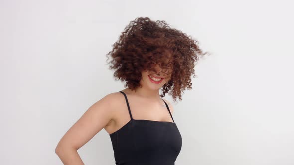 Mixed Race Black Woman with Freckles and Curly Hair in Studio on White Poses To a Camera