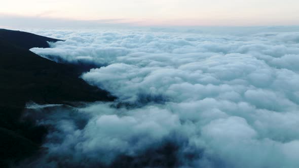 High altitude flight above fluffy cumulonimbus clouds, Bica da Cana, Madeira