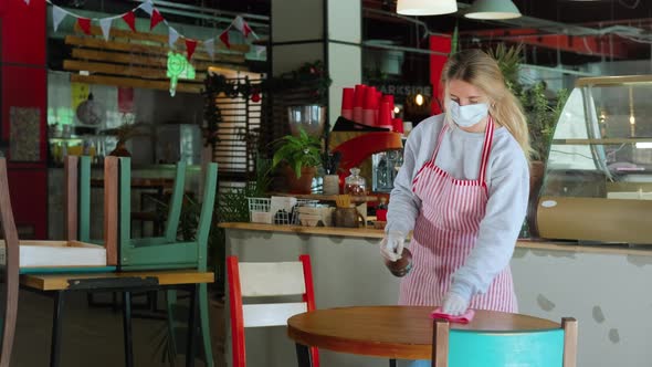 Cafe Owner Cleaning the Tables Before Opening Coronavirus Preventive Measures