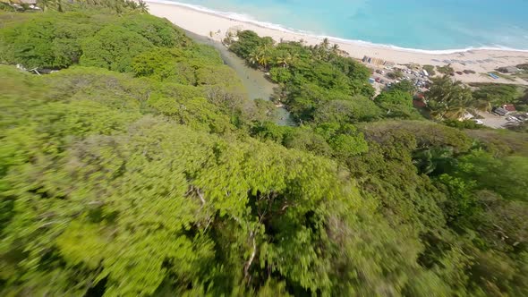 Los Patos river with locals swimming in clear water, Barahona; FPV drone