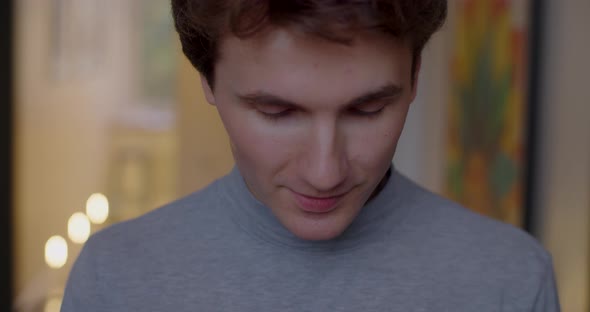 Close Up Portrait of Happy Man Drinking Hot Tea Indoors Slow Motion Handheld Device. Smiling Male