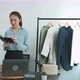 Young asian entrepreneurs check their clothes before selling them to customers. - VideoHive Item for Sale