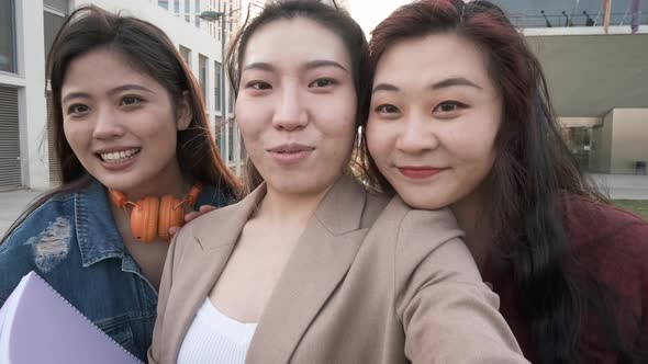 Three asian women taking a selfie. Student friends on the university campus.