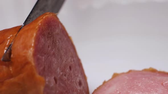 Cut sausage into slices close-up