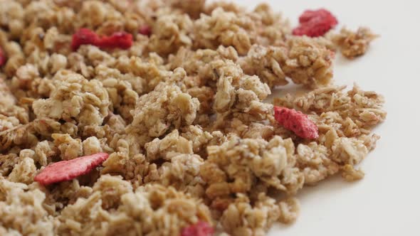 Panning over muesli with dehydrated strawberries  4K 2160p 30fps UltraHD footage - Tasty and  crunch