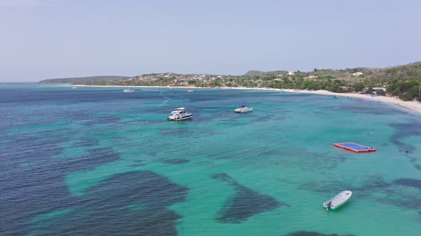 Lovely turquoise Caribbean with pleasure boats off tropical beach; aerial