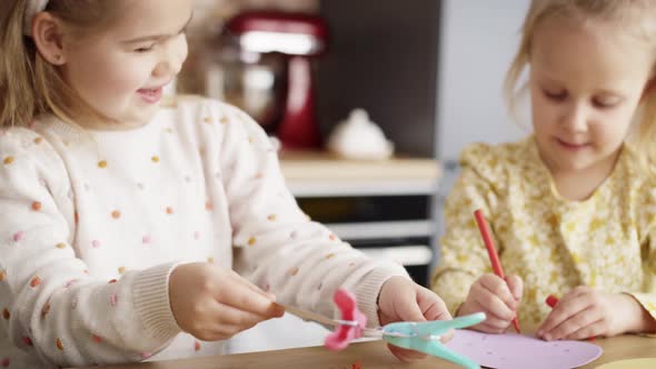 Video of two little girls preparing decorations for Easter. Shot with RED helium camera in 8K.