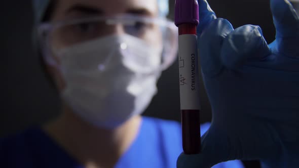 Doctor Holding Beaker with Coronavirus Blood Test