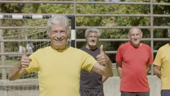 Happy Senior Football Player Standing in Sports Stadium