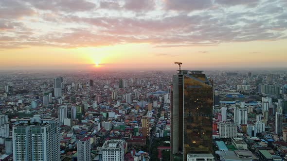 Skyscraper Construction Sites In Phnom Penh during beautiful sunset in background.Slow aerial forwar