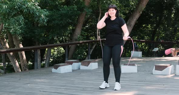 Plump Girl Jumps Rope in the Park