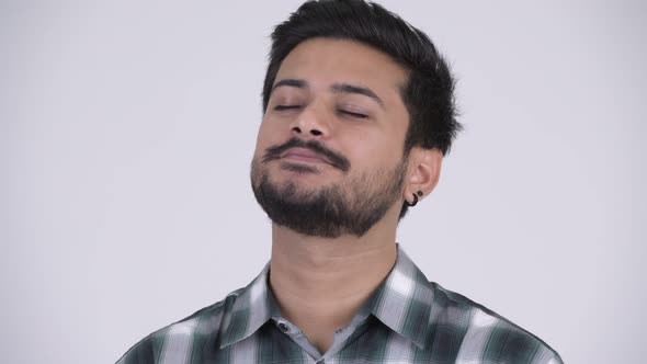 Young Happy Bearded Indian Man Relaxing with Eyes Closed