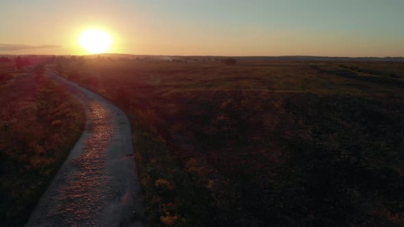 Scenic Countryside Landscape with Rural Road at Sunset