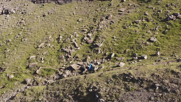 Drone Shot of Hikers Along Beautiful Mountains in Faroe Islands in Tjornuvik