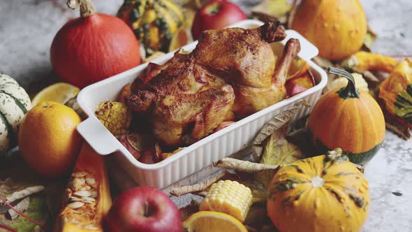 Thanksgiving Dinner Table with Roasted Whole Chicken or Turkey, Pumpkin, Baked Potatoes, Chestnuts