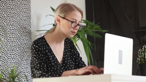 beautiful woman working on her laptop in home office
