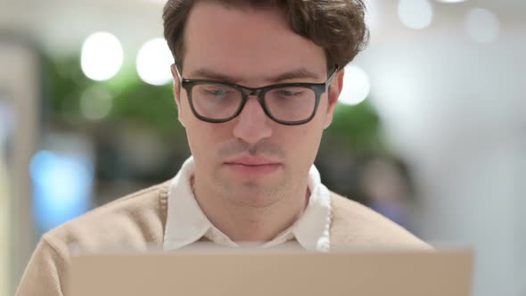 Close Up of Young Male Designer Working on Laptop