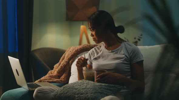 Asian Woman Watching Film During Dinner