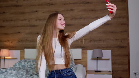 Smiling Cute Vlogger Girl Looking at Mobile Make Video Call Shooting Vlog Taking Selfie at Home