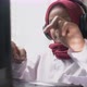 a little girl typing on laptop wearing headphone - VideoHive Item for Sale