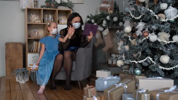 Little Girl with Mom Having Videocall in Xmas