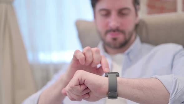 Portrait of Young Man Using Smart Watch