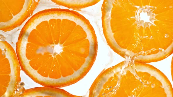 Super Slow Motion Shot of Splashing Orange Slice at 1000Fps alt