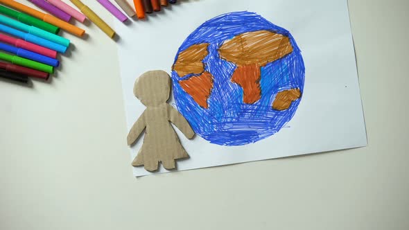 Child Putting Paper Family and Heart Sign Near Earth Painting, Saving Planet