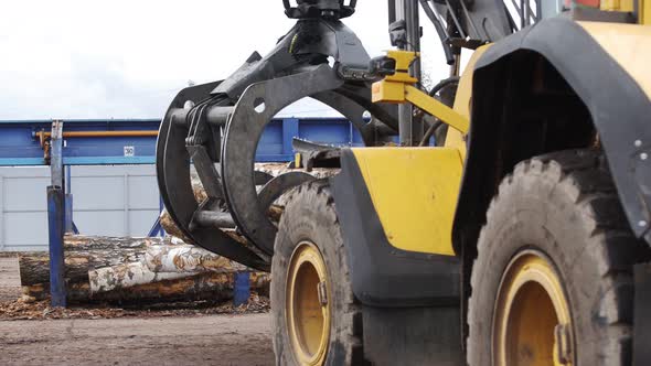 Loading Equipment for Logging. Log Loader for Timber, Logs. The Log Loader Moves a Stack of Pine