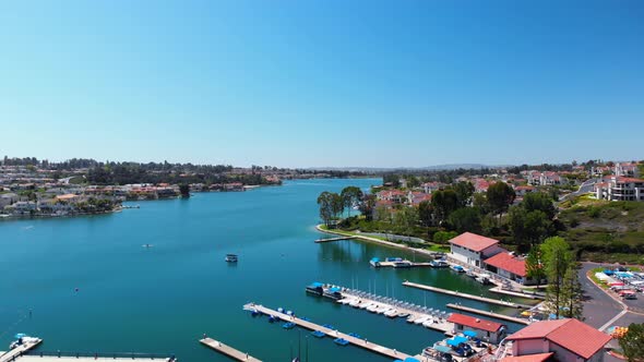 Aerial fly over of community lake mission viejo with a boat and paddleboard