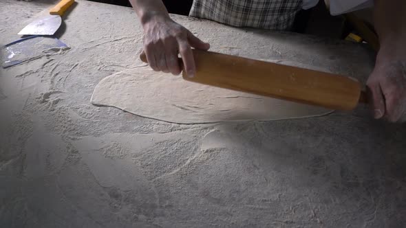 Rolling Out  Dough With Flour To Make Turkish Pita