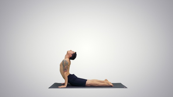 Flexible strong yoga man in Upward and Downward Facing