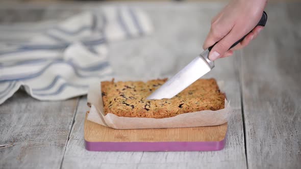 Cutting Homemade Berry Crumble Cake