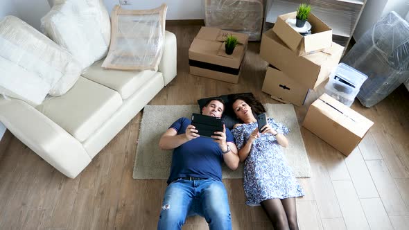 Couple Relaxing on the Floor of Their New Home