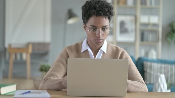 Working African Girl Using Her Laptop on Her Table